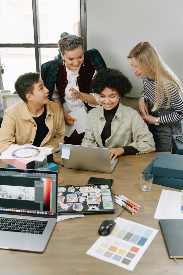 A diverse group of colleagues brainstorming ideas in a modern office setting, focusing on teamwork and creativity.